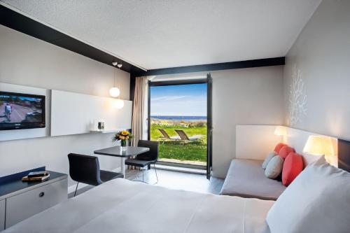 Superior sea side room with one queen size and one single beds offering a direct access to the garden with private long chairs