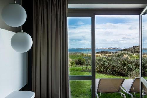 Superior sea side room with one queen size and one single beds offering a direct access to the garden with private long chairs