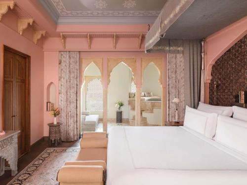 Raffles King Bedroom Suite with Plunge Pool & Balcony:Enjoy INR 4000 daily dining credit, one-time INR 4000 spa credit, signature Jaipur Sling at Writers Bar and 45-min Mineral Pool experience. Mughal-inspired interiors, private plunge pool with Aravallis