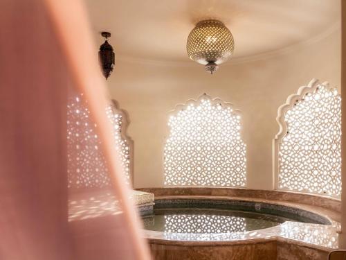 Raffles King Bedroom Suite with Plunge Pool & Balcony:Enjoy INR 4000 daily dining credit, one-time INR 4000 spa credit, signature Jaipur Sling at Writers Bar and 45-min Mineral Pool experience. Mughal-inspired interiors, private plunge pool with Aravallis