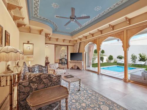 Maharani One King Bedroom Royal Suite with Pool: Airport Transfers in luxury vehicle, 01 Bottle of wine, INR 5000 hotel credit once during the stay. One 60-minute couple spa therapy. Evening Hi-Tea / Sundowner with Bartender, Butler Service
